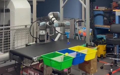 UR5 robot arm sorting bottles from a conveyor into colored bins